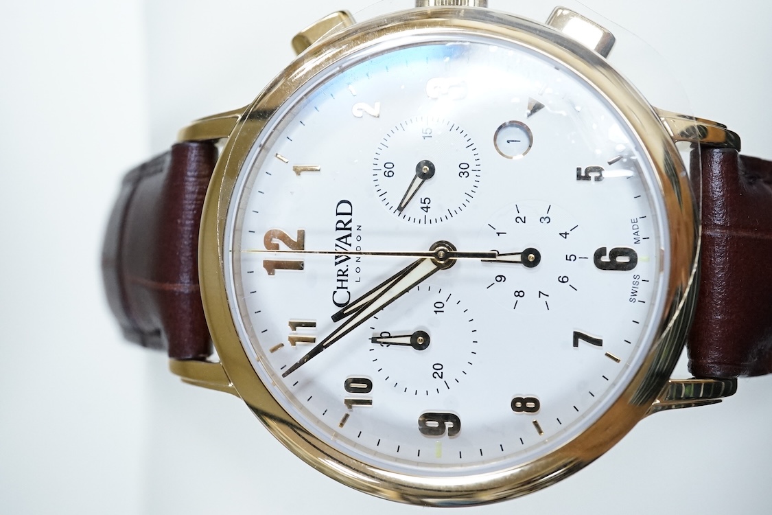 A boxed modern Christopher Ward of London gilt stainless steel chronograph quartz wrist watch, case diameter 40mm, on a Christopher Ward leather strap with deployment clasp, with papers but not for this model.